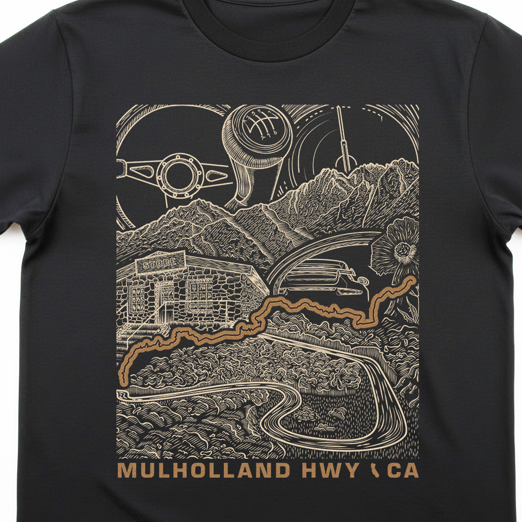 A black short-sleeve crewneck t-shirt featuring a detailed graphic print of Mulholland Highway in California. The graphic is rendered in a beige line-art style showing a vintage car, mountains, a building, and a gear shift pattern, with the text 'MULHOLLAND HWY (CA)' printed in beige at the bottom.