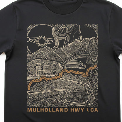 A black short-sleeve crewneck t-shirt featuring a detailed graphic print of Mulholland Highway in California. The graphic is rendered in a beige line-art style showing a vintage car, mountains, a building, and a gear shift pattern, with the text 'MULHOLLAND HWY (CA)' printed in beige at the bottom.